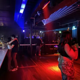 people dancing at a bar
