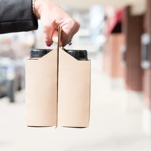 a hand holding two bottles
