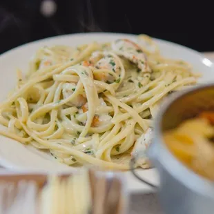 ows a plate of pasta with shrimp