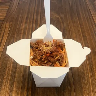 ows a fork in a takeout box