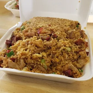 a takeout box of fried rice