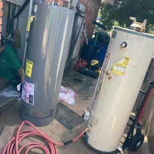 1-800-Plumber +Air technician replacing gas water heater..