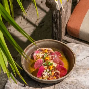 a bowl of food on a wooden table