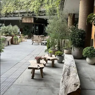 a patio with tables and benches
