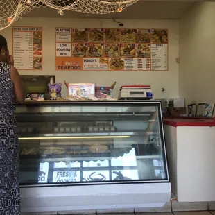 a woman standing in front of a display case