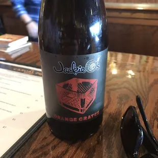 a bottle of wine and sunglasses on a table