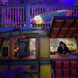 a woman behind a food truck