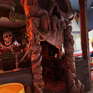 the entrance to a restaurant with a dinosaur statue