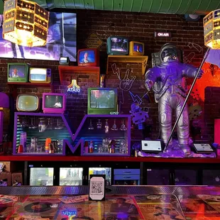 a man in a space suit standing on top of a table