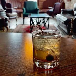  a glass of alcohol on a table