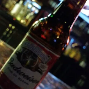 a bottle of beer on a bar counter