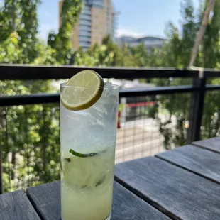 a glass of lemonade with a slice of lime