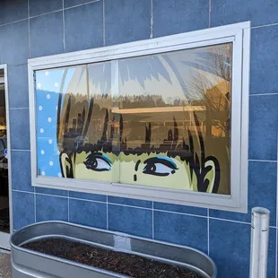 a reflection of a woman's face in a window
