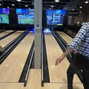 a man throwing a bowling ball