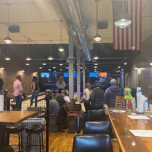 people sitting at tables in a restaurant
