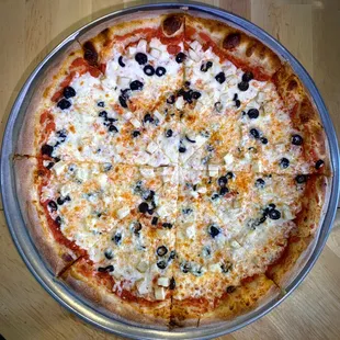 a pizza with olives and cheese