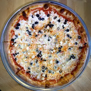 a pizza with olives and cheese