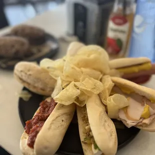 a plate of hotdogs and chips