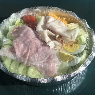 a salad in a foil container