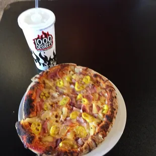 a pizza and a drink on a table