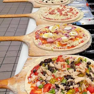 a row of pizzas