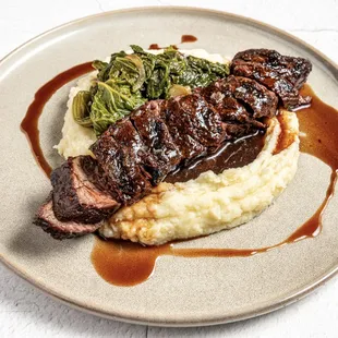 Bavette w/
Potato Mash Garlic Confit, Mustard Greens, Red Wine Jus