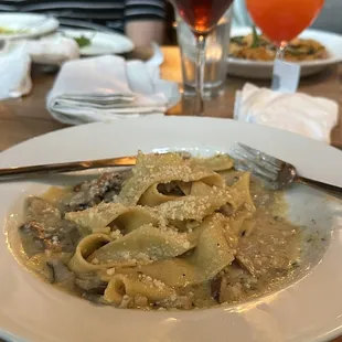 a plate of pasta and a glass of wine