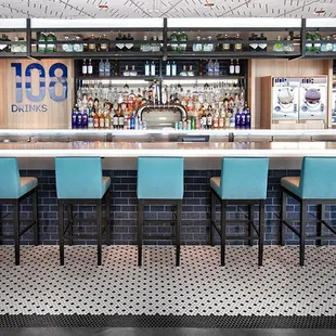 a view of a bar with blue chairs