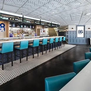 a bar with blue chairs and a checkered floor