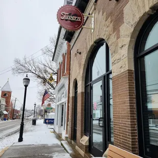 a bench in front of a brick building