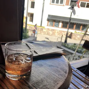 a glass of whiskey on a table