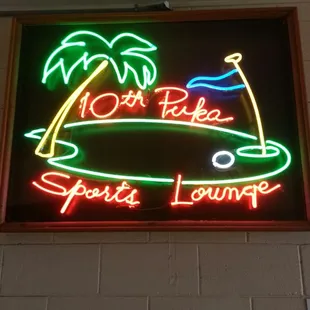 a neon sign for a sports lounge