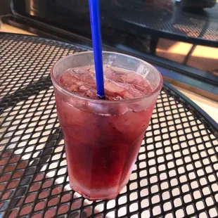 a drink in a plastic cup with a blue straw