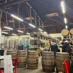 a group of people standing around barrels