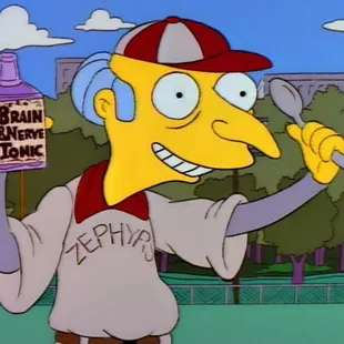 a man in a baseball uniform holding a drink