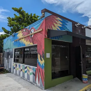 a colorful building with a bird painted on it