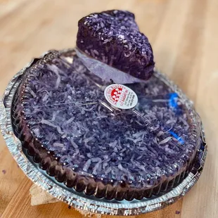 ube cake topped with coconut flakes