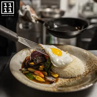 a plate of food with rice and a fried egg