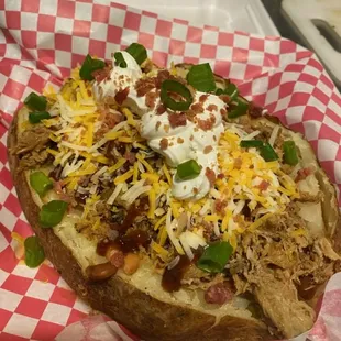 Loaded potato butter pinto beans brisket sour cream cheese bacon bits and scallions