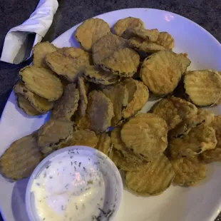 a plate of fried potato chips and dip