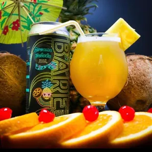 a can of beer and a glass of orange juice