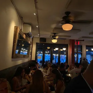 people sitting at tables in a restaurant