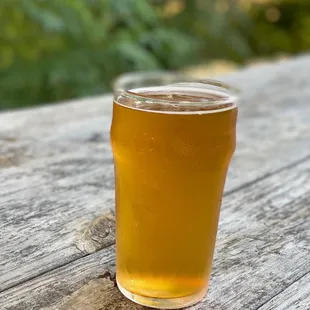 a pint of beer on a picnic table