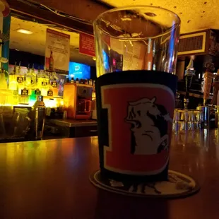a glass of beer on a bar