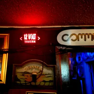 a neon sign for 12 war tavern