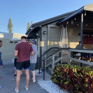 a group of people standing outside of a restaurant