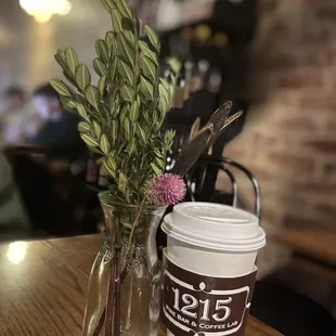 a cup of coffee and a flower