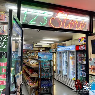 a storefront with a neon sign