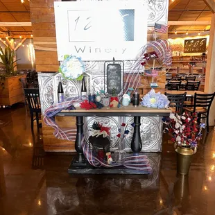 a table with wine bottles and flowers