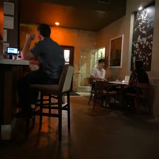 a man sitting at a table in a restaurant